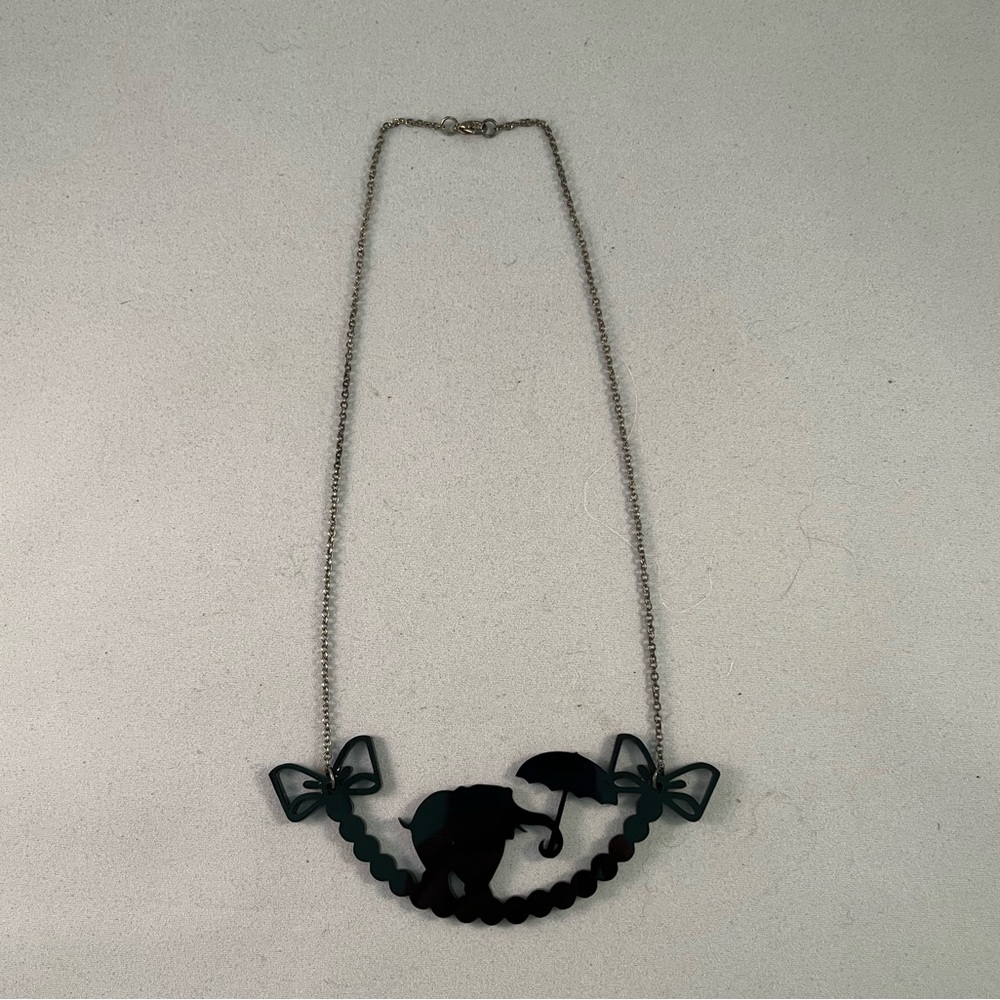 Acrylic elephant, bow, and pearl shadow necklace